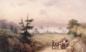 Une famille noire avec une charrette sur un chemin de terre à la campagne.