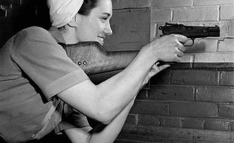 A worker with a Browning Hi-Power pistol
