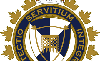 A circle with the motto "Protectio Servitium Integritas." The circle is surrounded by maple leaves and a crown on top. Inside the circle is a shield with a design featuring a medieval gate.
