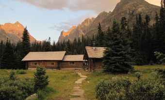 Hut with mountains in the background.