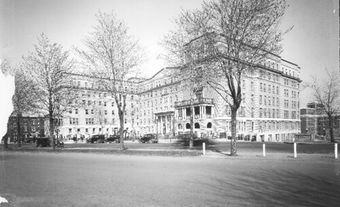 A large building with a few trees in front of it.