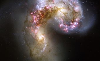 Two galaxies coming together in a C-shape.