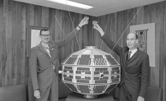 John Chapman (left) and Leroy Nelms (right) toasting the Alouette Satellite.