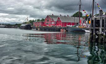 Red building and wharf by the water.