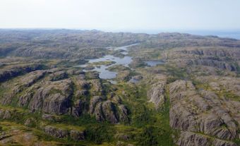 Rocky, mountainous terrain with some lakes and conifers in the lowlands.