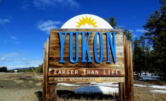 Large Yukon tourism sign reading “Yukon / larger than life / plus grand que nature.”