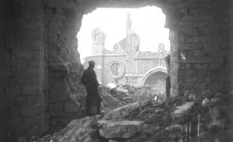 A Canadian soldier looking through the south entrance of the Cathedral in Ypres, 1917.