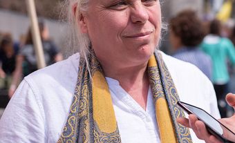 Manon Massé with a scarf and a white shirt.