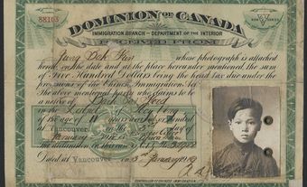A paper certificate with the picture of a young Chinese boy.
