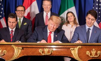 Photo of North American leaders signing CUSMA