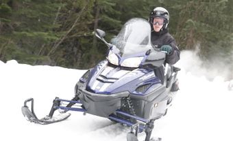 Photo of a person riding a snowmobile