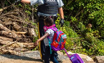 An asylum seeker crosses into Canada at Roxham Road