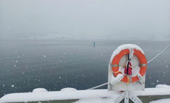 A snowy wharf and bay.